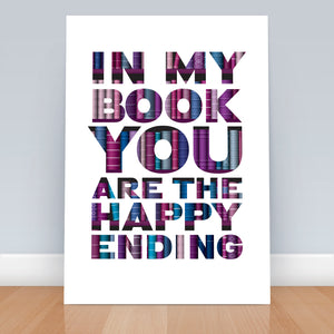 A4 print on floor next to wall saying "In my book you are the happy Ending" in purple with bookshelves detail.